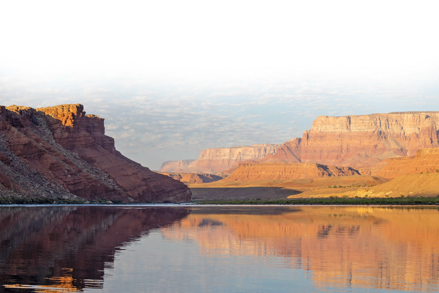 Glassy, reflective river in the Grand Canyon.