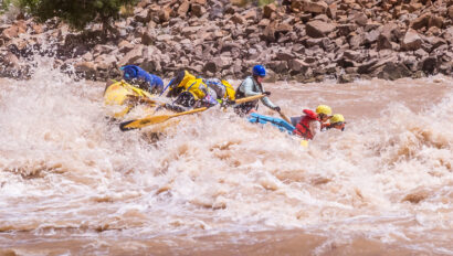 An OARS guide rows a raft through whitewater in Cataract Canyon in Utah