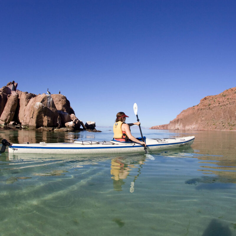Woman sea kayaking in Baja, Mexico.