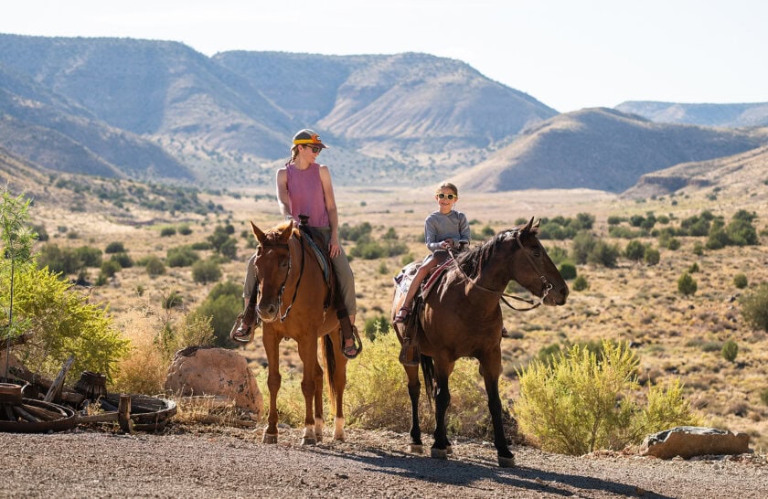 A mom and daughter on horseback at Bar 10 Ranch