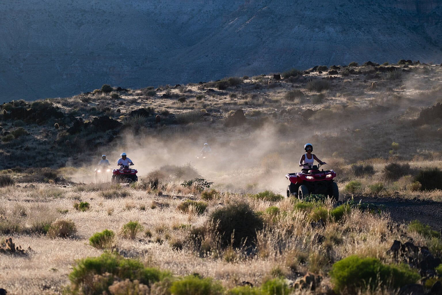A group rides ATVs on a tour of the rim of Grand Canyon around Bar 10 Ranch