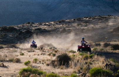 A group rides ATVs on a tour of the rim of Grand Canyon around Bar 10 Ranch