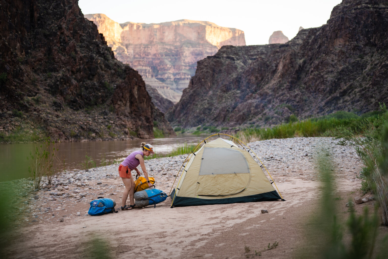 A woman sets up her campsite along the Colorado River in Grand Canyon