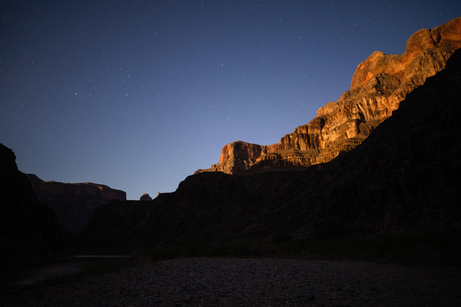Stars shine above canyon walls in Grand Canyon