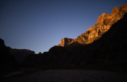 Stars shine above canyon walls in Grand Canyon