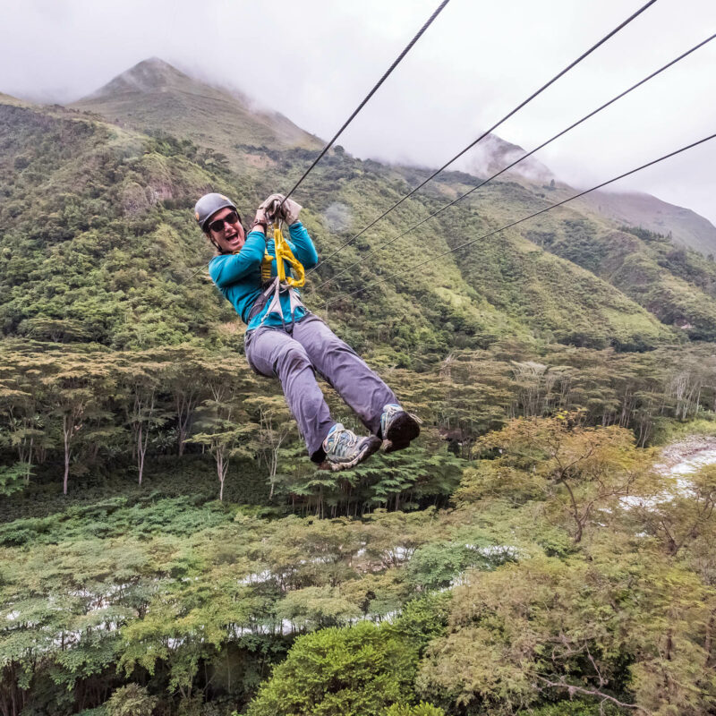 Woman ziplining Cola de Mono Peru.
