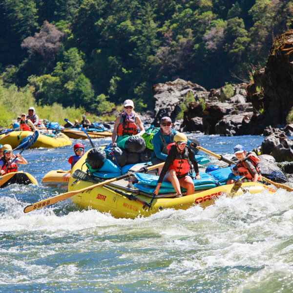 Oar rafts and inflatable kayaks tackle rapids on a family adventure down Oregon's Rogue River with OARS