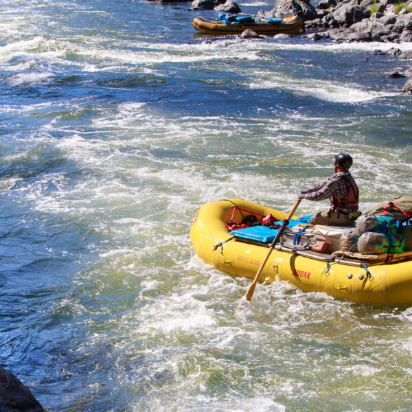 A solo baggage boater rows down the Rogue River in Oregon