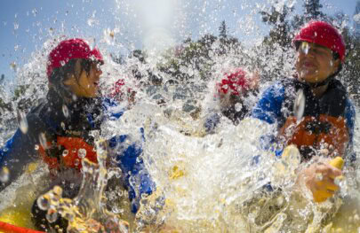 A front view of rafters getting splashed by whitewater on the South Fork of the American River in California