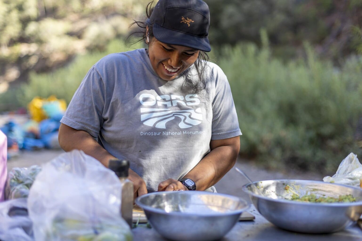 An OARS guide cooks during a Tuolumne River rafting trip