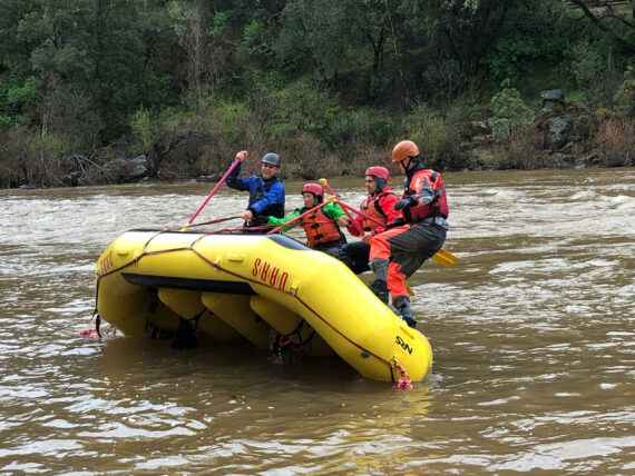 Guides doing raft flipping drills.